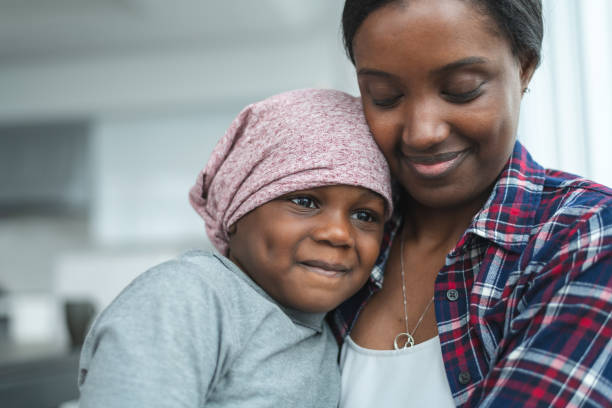 istock Supportive mother holds child with cancer 1175052401