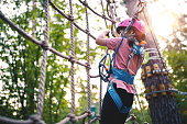 Girl overcomes obstacles in Adventure Rope Park