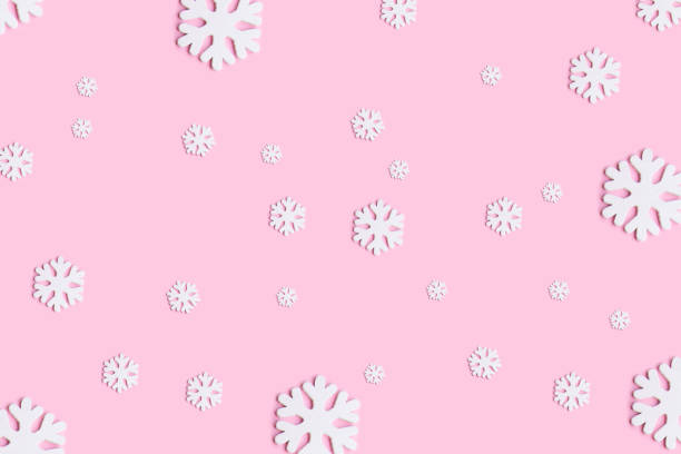 istock White christmas snowflakes decoration on pink background. 1175053157