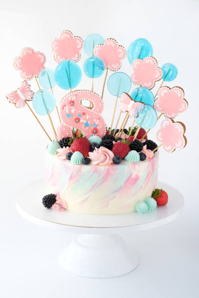 istock Birthday cake, decorated with a colorful sweets and berries  on a white background. 1175054770
