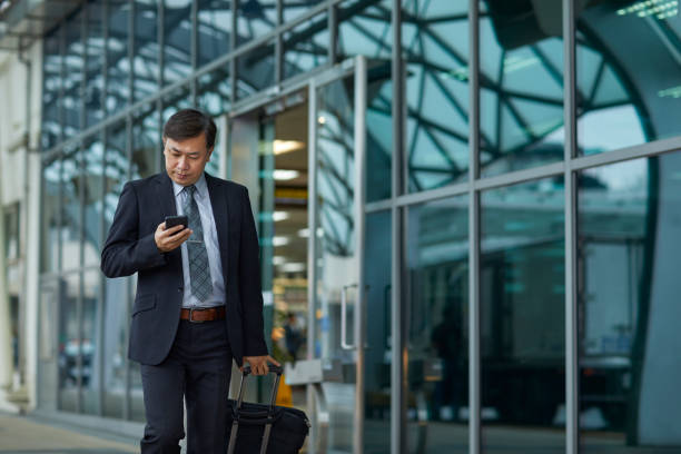 istock Professional using mobile phone outside airport 1175054809