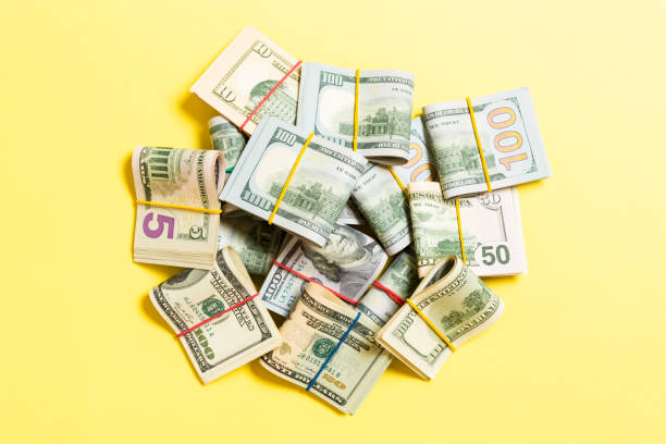 istock Many Stack of 100 dollar bills. Isolated on colored background top wiev with copy space 1175055126