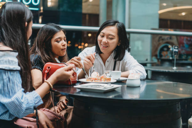 istock Three friends eating a dessert at the restaurant together 1175056332
