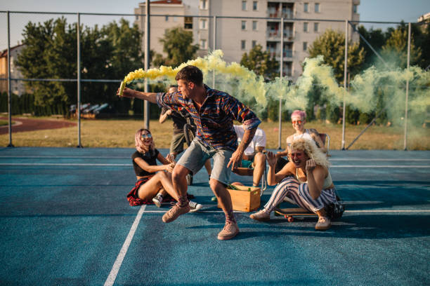 istock Man playing with a smoke bomb around his friends 1175057327