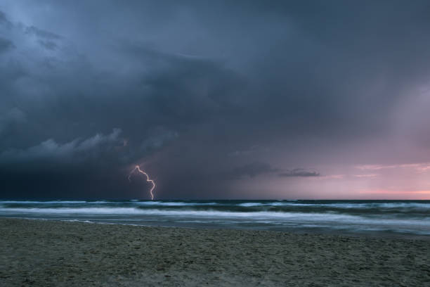 istock Dramatic view of a thunderstorm with lightning strike in the sea at dusk 1175059205