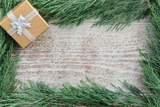 istock Christmas cypress branches border on a wooden background 1175059578