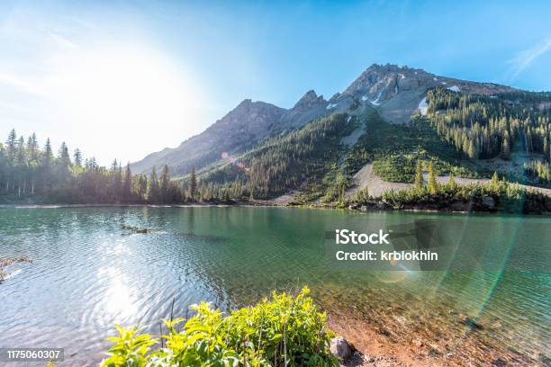 Maroon Bells Rocky Mountain Snow Peak View With Creater Lake In Colorado In Summer Wide Angle View With Bright Sun And Flare Stock Photo - Download Image Now