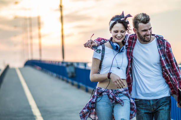 istock Young attractive couple carrying skateboard 1175060431