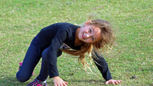 istock Child practicing tumbling and gymnastics outside, having fun in the sun 1175060598