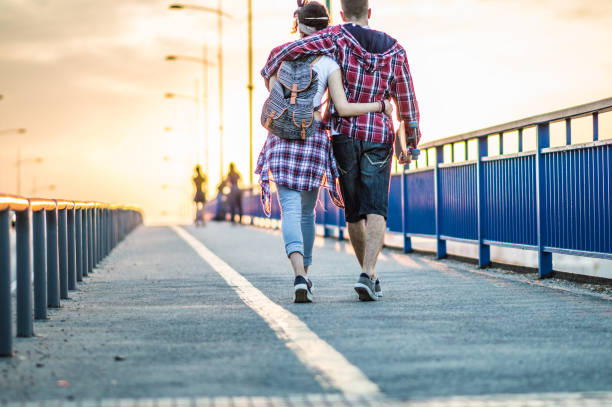 Young couple in love  holding hands and walking street