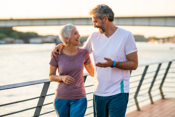 istock Senior couple jogging by the river 1175060807