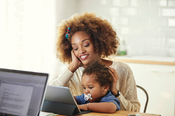 istock Mother looking at son with digital tablet at home 1175060812