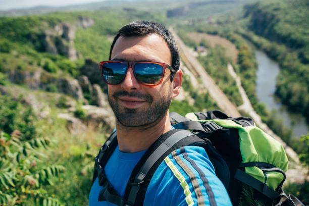 istock Tourist man taking selfie in the mountain 1175060819