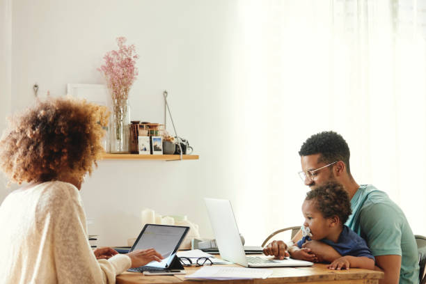 istock Mother and father sitting with son at table 1175060823