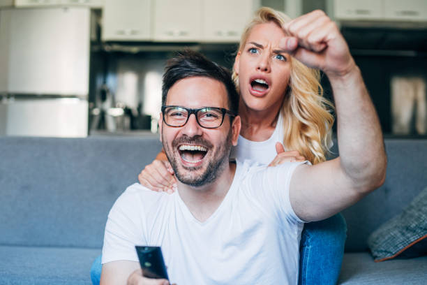 istock Young couple watching sport on tv. 1175060938