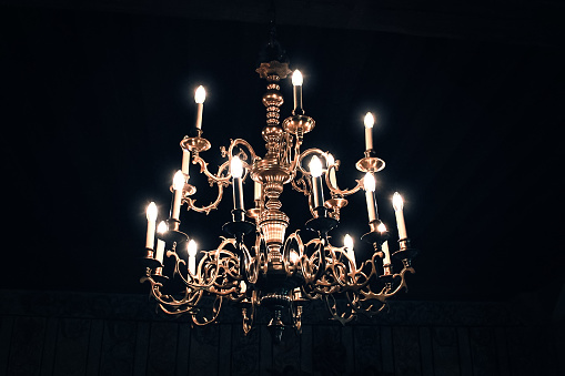 vintage chandelier shines in the dark