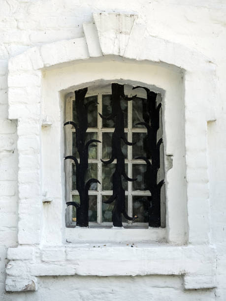 istock antique white window in a white brick frame and forged lattice, closeup 1175062051