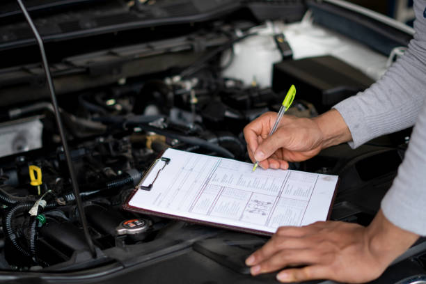 istock Auto mechanic (or technician) checking car engine at the garage 1175063910