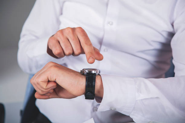 istock business man hand watch 1175064419