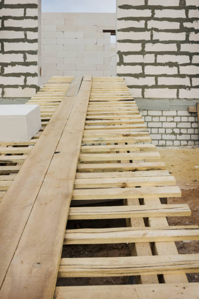 istock Enter a wooden gangway intol building under construction 1175064454