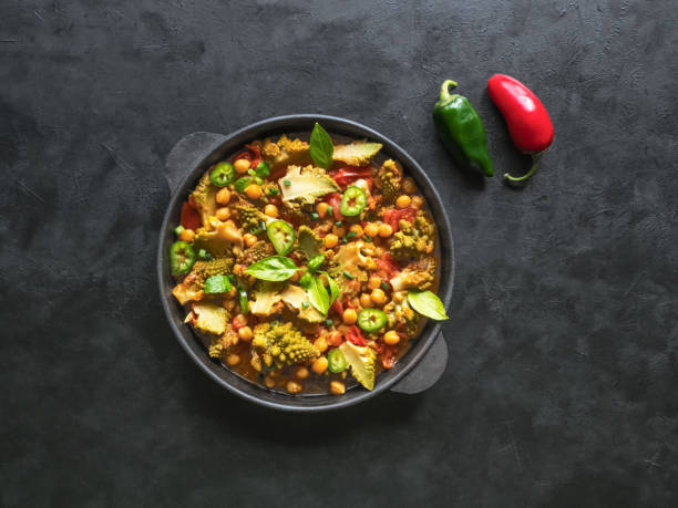 istock Nutty roasted romanesco curry in a black background. Top view. 1175065646