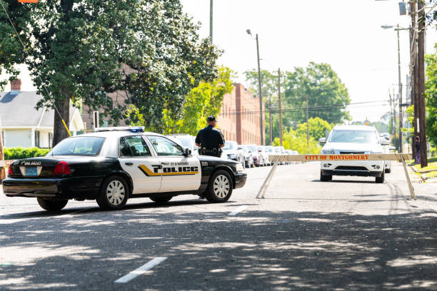Alabama city police officer or policeman car on street with sign on sidewalk with blocked road block or roadblock stock photo