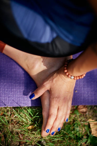 istock Woman practicing yoga in park. 1175067315