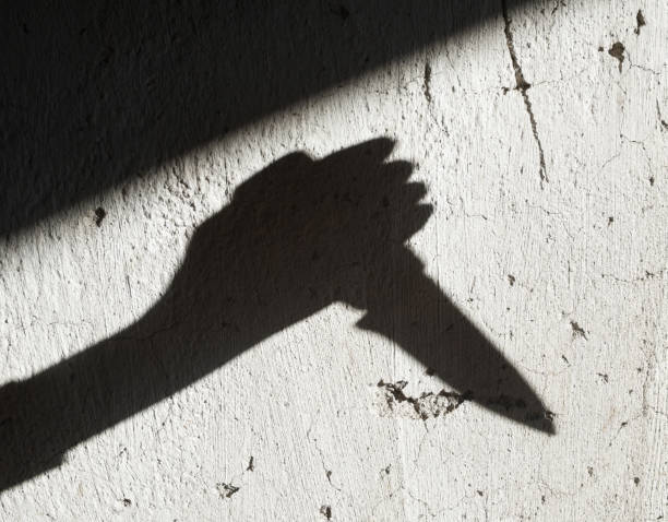 istock Shadow of the hand holding a knife 1175068775