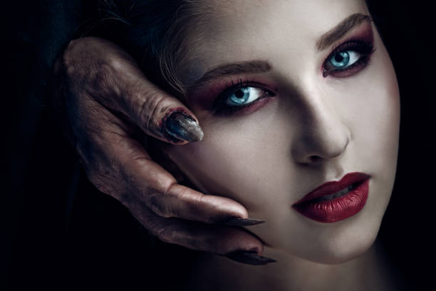 Creepy portrait of beautiful woman Demon touching face of young beautiful woman. Halloween theme. vampire woman stock pictures, royalty-free photos & images