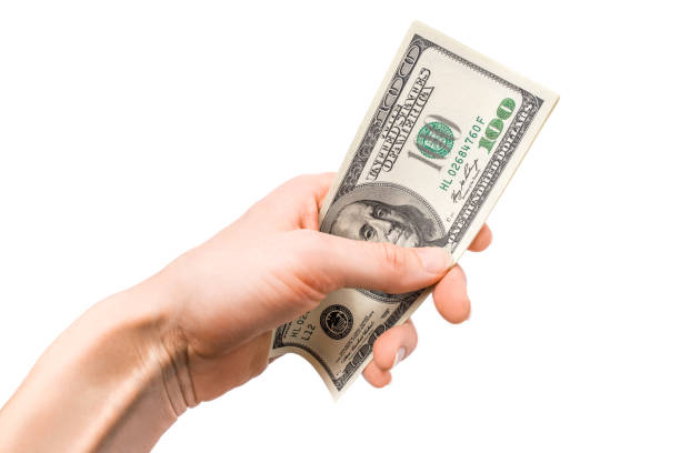 istock Dollars in woman hand isolated on white background. 1175073491