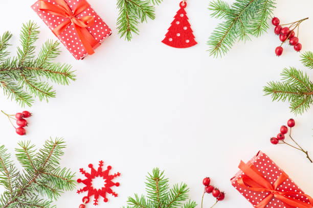 istock Flat lay frame with evergreen tree branch, christmas decorations and gift box on a white background 1175074317
