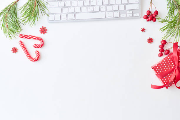 istock Flat lay christmas home office desk with pine branches and keyboard, christmas decorations  on a white background 1175074322
