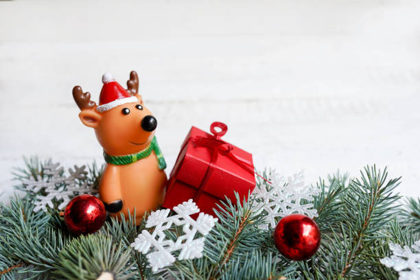istock Christmas card with deer and gift box and Christmas decorations on a white background 1175074805
