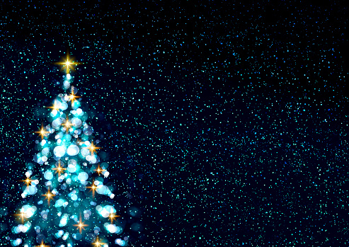 Christmas tree with lights isolated on blue sky background.