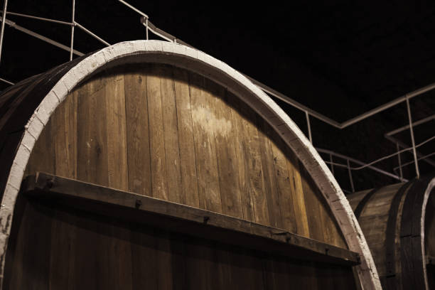 Old wooden barrel in dark winery, close-up Old wooden barrel in dark winery, close-up photo with selective focus inkerman stock pictures, royalty-free photos & images