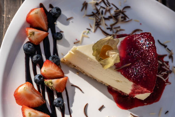 istock classic cheesecake with raspberry jam on a plate decorated with fresh strawberries 1175076857