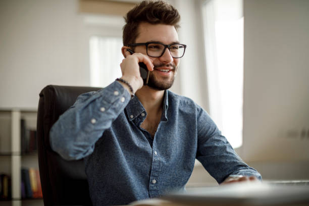 istock Smiling businessman talking on the phone 1175076890
