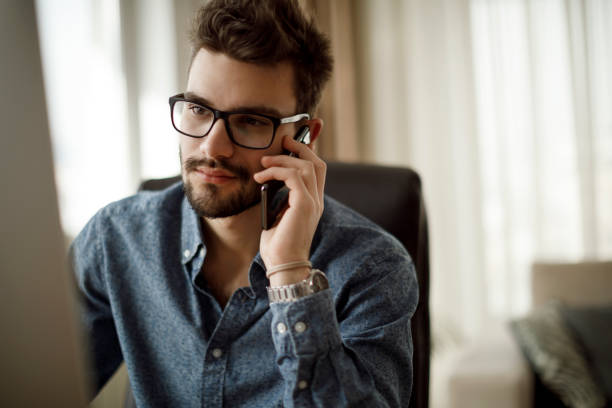 istock Smiling young businessman talking on the phone 1175076901
