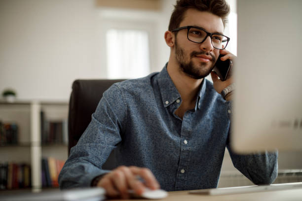 istock Smiling businessman talking on the phone 1175077026