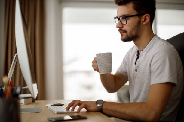 istock Young man working from his home office 1175077126