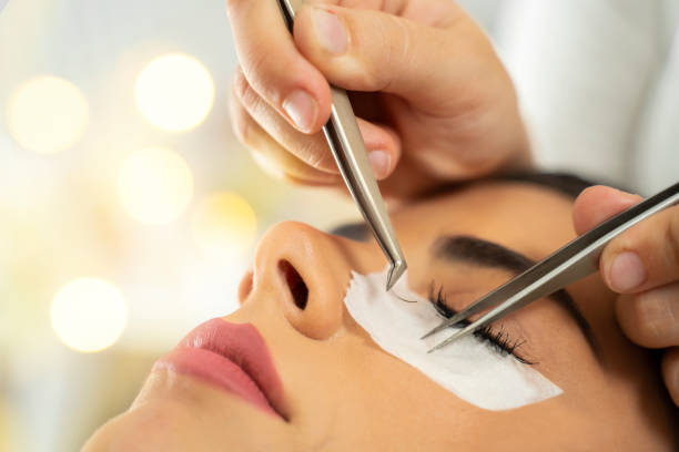 istock Eyelash extension closeup, hand implements eyelashes 1175079367