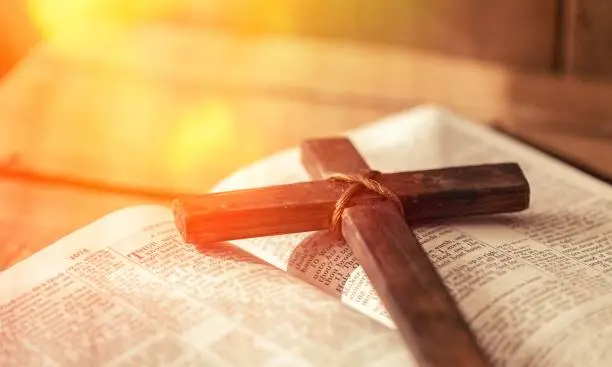 Holy Bible book and cross, close-up view