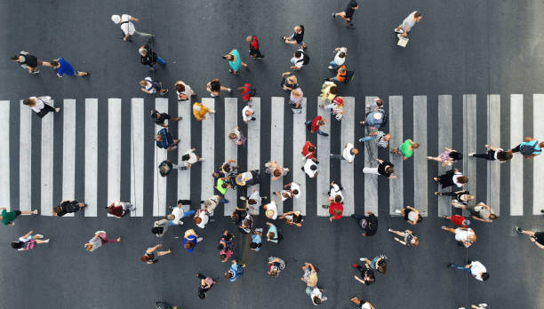 istock People crowd moving through the pedestrian crosswalk. Top view from drone. 1175080108