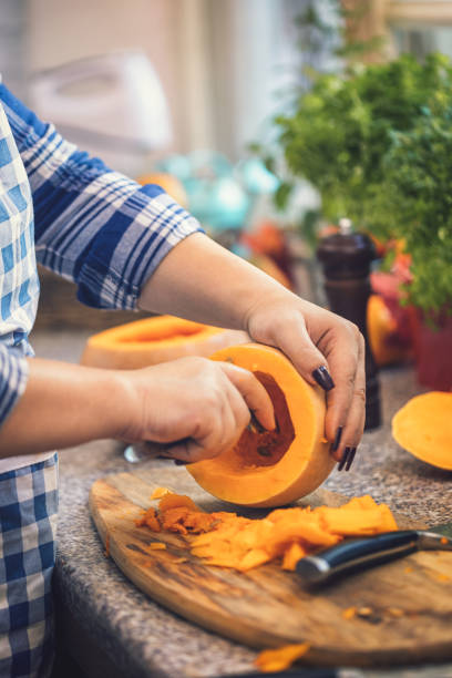 istock Young woman preparing pumpkin soup at home 1175080175