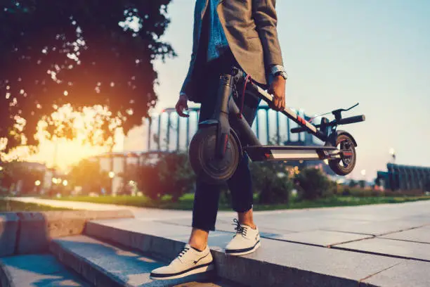 Young businessman with e-scooter