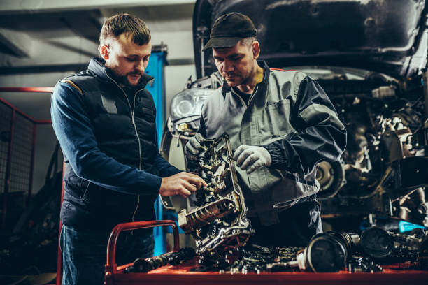 istock Mechanics repairing car engine 1175082855