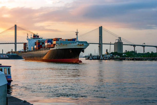 istock Dusk falls over the last Container Ship loaded for today, ready to head down the Savannah River t the Atlantic Ocean 1175084067