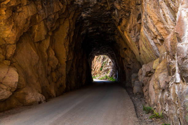 istock Tunnel and road curving through red rock sandstone 1175084691