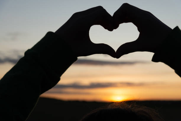 istock Heart silhouette at sunset 1175084816