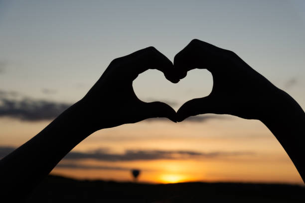 istock Heart silhouette at sunset 1175084901